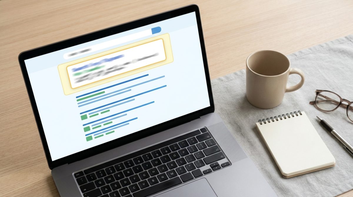 A laptop screen showing a Google search results page with an AI-generated summary box at the top above a list of traditional blue organic links